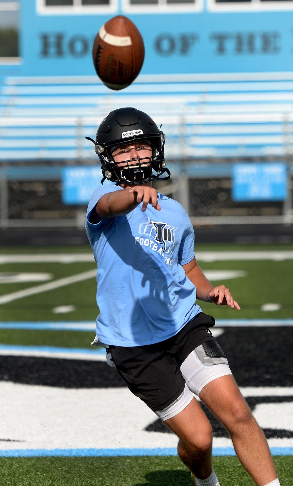 North Mac quarterback Dane Vance flicks the ball to a receiver during a drill at practice Monday, August 7, 2023.