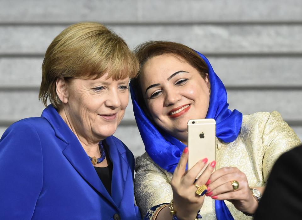 German Chancellor Angela Merkel poses for a selfie with Afghan politician Shukria Barakzai at the German Chancellery in Berlin, Germany, on Sept. 16, 2015.
