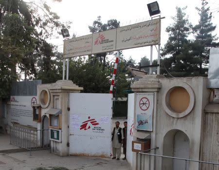 Afghan guards stand at the gate of Medecins Sans Frontieres (MSF) hospital after an air strike in the city of Kunduz, Afghanistan October 3, 2015. REUTERS/Stringer