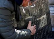 The Wider Image: Japan's tsunami survivors call lost loves on the phone of the wind