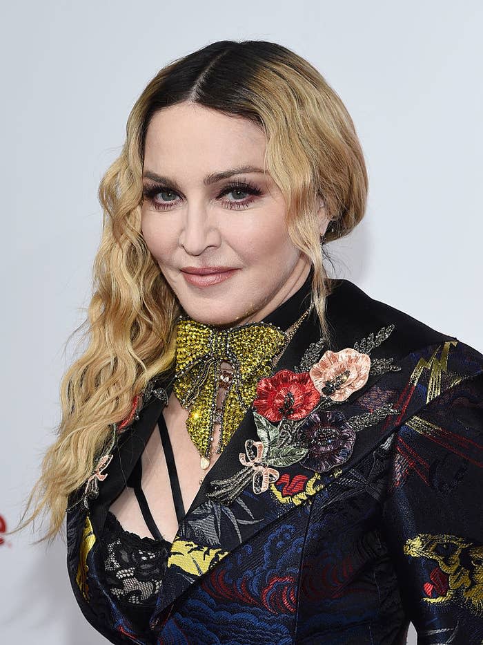 Madonna attends an event wearing an embroidered blazer with a floral brooch