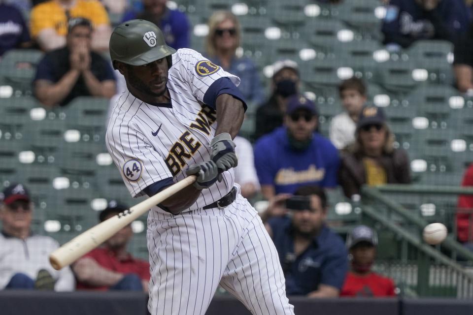 Milwaukee Brewers' Lorenzo Cain hits a two-run scoring single during the seventh inning of a baseball game against the Atlanta Braves Sunday, May 16, 2021, in Milwaukee. (AP Photo/Morry Gash)