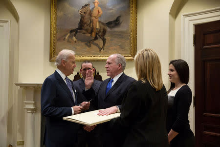 U.S. Vice President Joe Biden (L) swears in CIA Director John Brennan (C) in the Roosevelt Room of the White House in Washington, DC, U.S. on March 8, 2013. Courtesy David Lienemann/The White House/Handout via REUTERS