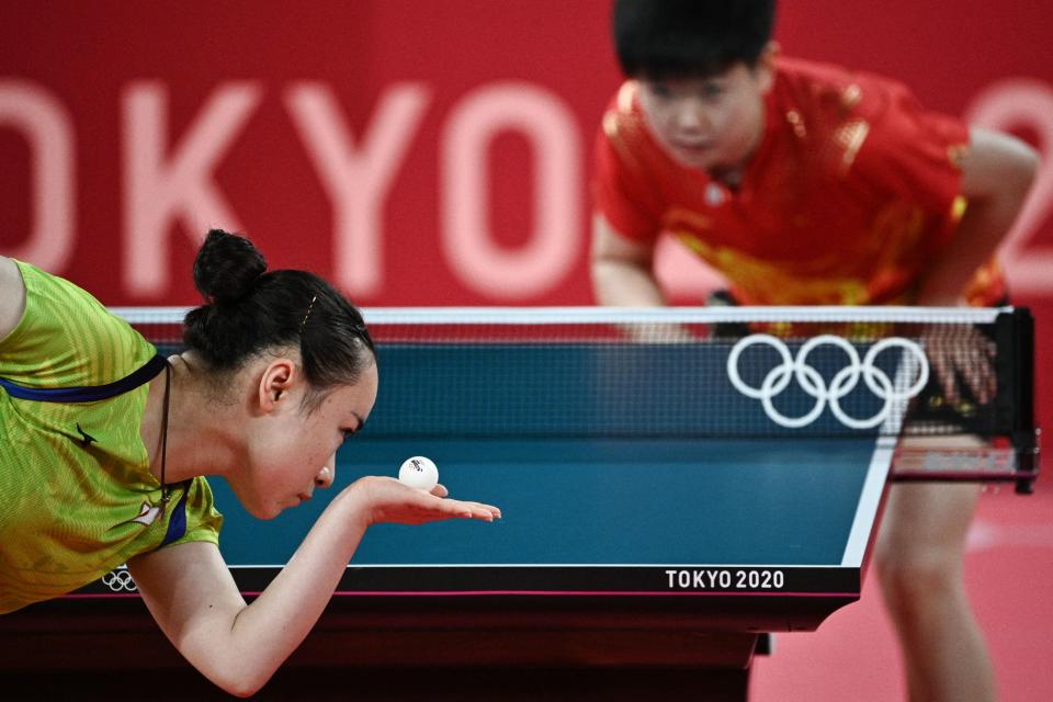 <p>Japan's Mima Ito (L) serves to China's Sun Yingsha during their women's singles semifinals table tennis match at the Tokyo Metropolitan Gymnasium during the Tokyo 2020 Olympic Games in Tokyo on July 29, 2021. (Photo by Anne-Christine POUJOULAT / AFP)</p> 