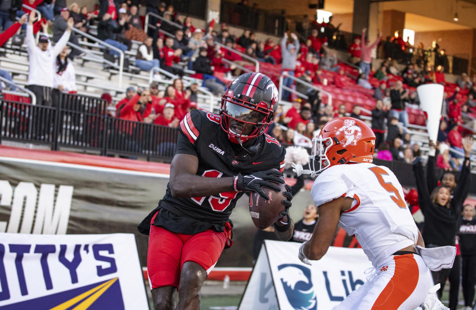 Western Kentucky wide receiver Craig Burt Jr. (19) catches a touchdown pass past Sam Houston defensive back David Fisher (5) during an NCAA college football game Saturday, Nov. 18, 2023, in Bowling Green, Ky. (Grace Ramey/Daily News via AP)