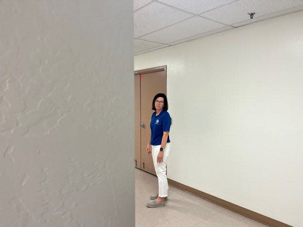 Julie McKee, human resources supervisor for the Justice Courts of Maricopa County, stands in the basement of the Security Building on August 18, 2023. McKee heard high heels following her the last time she was in the basement. She believes the building is haunted.