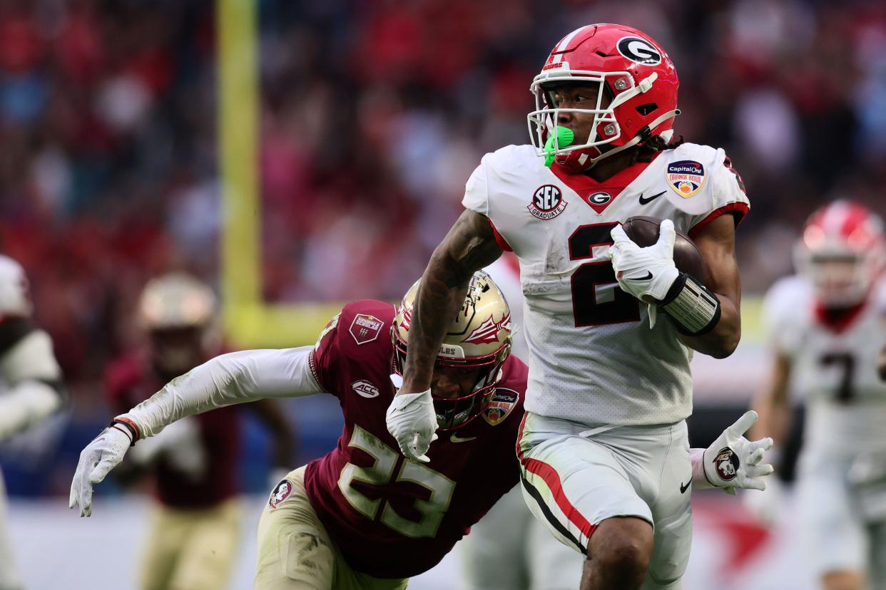 Georgia Bulldogs running back Kendall Milton (2) rushes the ball against the Florida State Seminoles during the first half in the 2023 Orange Bowl on December 30, 2023, at Hard Rock Stadium in Miami Gardens, Florida.