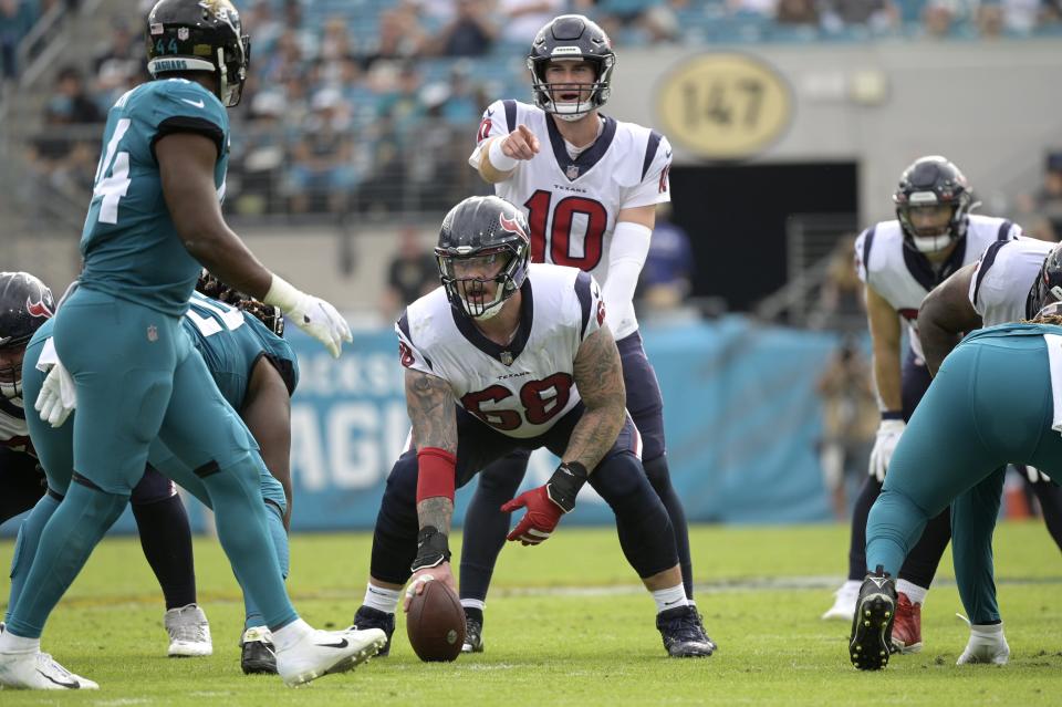 Houston Texans quarterback Davis Mills (10) calls out instructions behind center Justin Britt (68) during the first half of an NFL football game against the Jacksonville Jaguars, Sunday, Dec. 19, 2021, in Jacksonville, Fla.