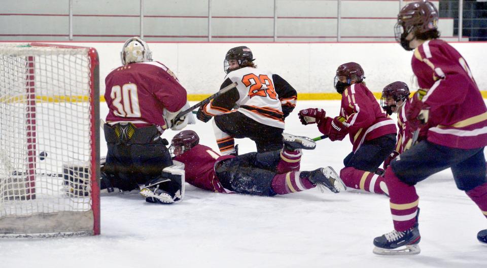 Algonquin Regional High School goalie Colin Connors and Marlborough High School hockey captain Anthony Giansanti (#23)  at the Daily News Cup tournament at the New England Sports Center, Dec. 29, 2021.