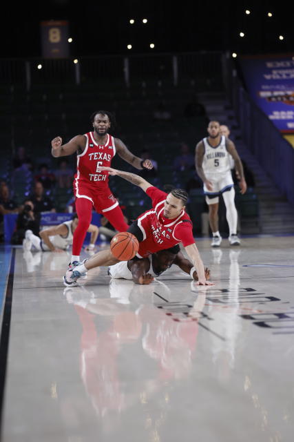 Texas Tech's Pop Isaacs, top, center, and Villanova's TJ Bamba go down during the third quarter of an NCAA college basketball game in the Battle 4 Atlantis at Paradise Island, Bahamas, Wednesday, Nov. 22, 2023. (Tim Aylen/Bahamas Visual Services via AP)