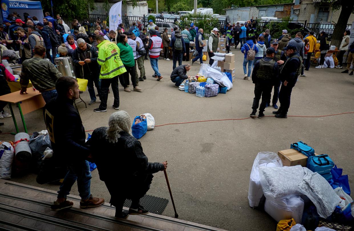 Ukrainian evacuees wait to register at the evacuation center which receives people who had to leave territories close to the Russian border in Kharkiv (EPA)