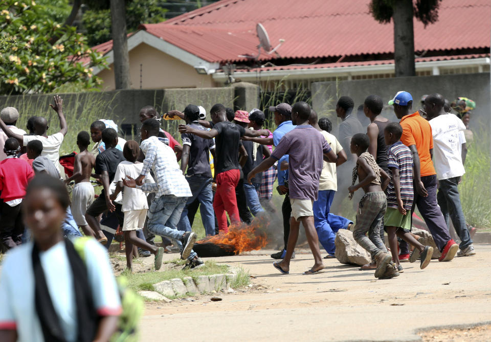 Protestors gather on the streets during demonstrations over the hike in fuel prices in Harare, Zimbabwe, Monday, Jan. 14, 2019. Protesters have blocked roads in some parts in Zimbabwe's capital after the government more than doubled the price of gasoline. (AP Photo/Tsvangirayi Mukwazhi)