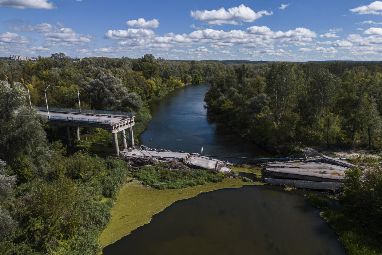 A view on destroyed bridge across Siverskiy-Donets river in the recently retaken area of Izium, Ukraine, Monday, Sept. 19, 2022. Residents of Izium, a city recaptured in a recent Ukrainian counteroffensive that swept through the Kharkiv region, are emerging from the confusion and trauma of six months of Russian occupation, the brutality of which gained worldwide attention last week after the discovery of one of the world's largest mass grave sites. (AP Photo/Evgeniy Maloletka)