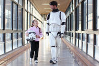 SYDNEY, AUSTRALIA - APRIL 11: Jacob French walks with patient Helena Kantarelis at the Sydney Children's Hostpital on April 4, 2012 in Sydney, Australia. French today completed the over 5,000 km trek from Perth to Sydney on foot, donning a full body stormtrooper costume he successfully raised over $100,000 for the Starlight Children's Foundation. Since July 2011, Jacob has walked 10 hours a day, Monday to Friday, lost over 12kg in weight, and gone through seven pairs of shoes. The Starlight Children's Foundation provides programs to help lift the spirits of sick children in hospitals accross Australia. (Photo by Cameron Spencer/Getty Images)