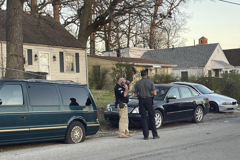 Anthony Krock, Fort Wayne Police Department on-call public information officer, talks with an officer on the scene of a shooting that broke out during a memorial at McCormick Park on Wednesday, April 12, 2023, in Fort Wayne, Ind. Multiple people were wounded, according to police. (Corryn Brock/The Journal-Gazette via AP)