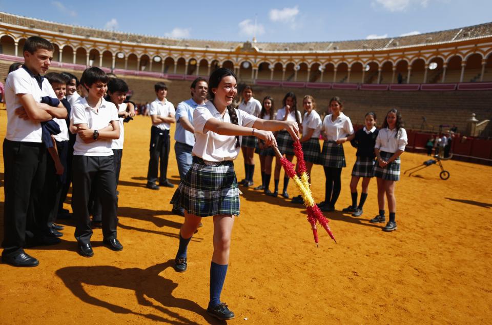 A student holds a pair of banderillas during a bullfight master class for schoolchildren at the Maestranza bullring in the Andalusian capital of Seville, southern Spain, April 23, 2014.