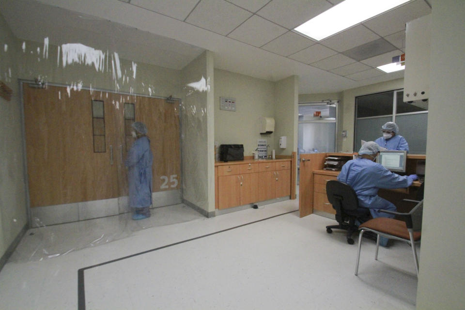 In this May 14, 2020 photo, a plastic sheet separates an area reserved for the care of COVID-19 patients at a hospital in Tijuana, Mexico. It remains unclear where the first coronavirus cases in Tijuana originated. While the U.S. is one possibility, the city also sees many international visitors and has numerous links with Mexico City, which is by far the hardest-hit place in the country. (AP Photo/Joebeth Terriquez)