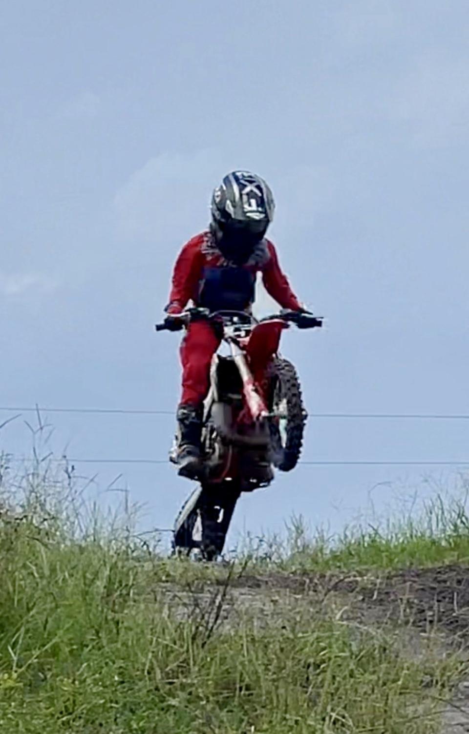 Motocross riders under training with Hannah Hodges, of Pierson, perform stunts during training at a private track on Sept. 12.