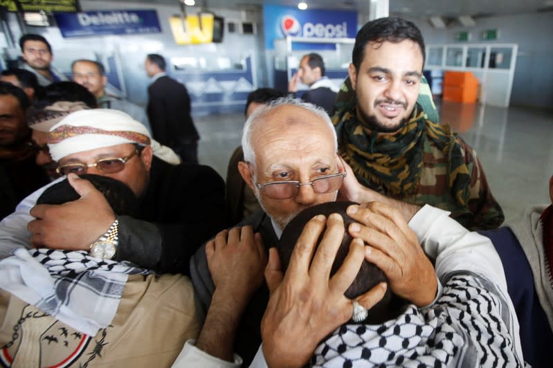 Houthi detainees freed by the Saudi-led coalition are greeted upon their arrival at Sanaa airport in Sanaa, Yemen