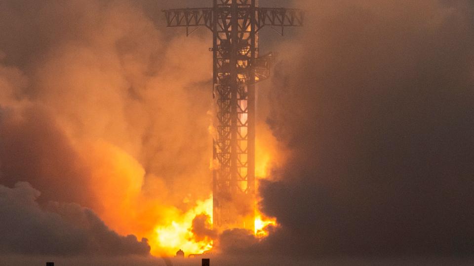 a large white and black rocket lifts off