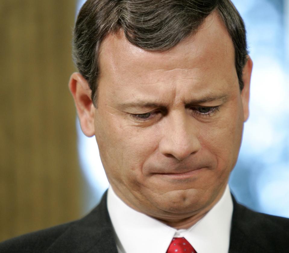 Supreme Court nominee John Roberts listens as President Bush nominates him for Chief Justice.