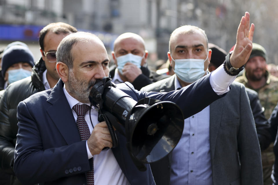 Armenian Prime Minister Nikol Pashinyan speaks through a loudspeaker during a rally in the central in Yerevan, Armenia, Thursday, Feb. 25, 2021. Armenia's prime minister accused top military officers on Thursday of attempting a coup after they demanded he step down, adding fuel to months long protests calling for his resignation following the nation's defeat in a conflict with Azerbaijan over the Nagorno-Karabakh region. (Tigran Mehrabyan/PAN Photo via AP)
