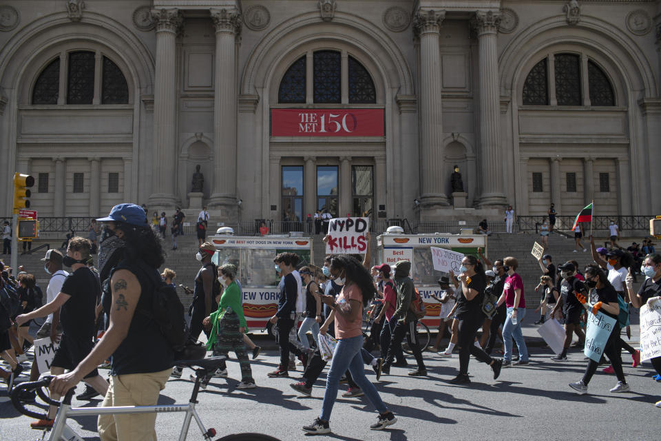 Protesters march past the Metropolitan Museum during a solidarity rally for George Floyd, Saturday, May 30, 2020, in New York. Demonstrators took to the streets of New York City to protest the death of Floyd, a black man who died after being taken into police custody in Minneapolis on Memorial Day. (AP Photo/Wong Maye-E)