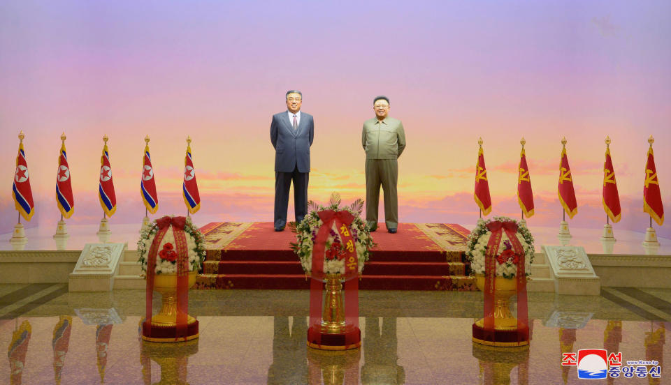 The statues of Kim Il Sung and Kim Jong Il are seen during a ceremony