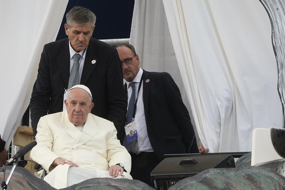 Massimiliano Strappetti, right, follows Pope Francis as he meets young people and elders at Nakasuk Elementary School Square in Iqaluit, Canada, Friday, July 29, 2022. Francis has promoted the Vatican nurse whom he credited with saving his life to be his "personal health care assistant." The Vatican announced the appointment of Massimiliano Strappetti, currently the nursing coordinator of the Vatican's health department, in a one-line statement Thursday, Aug. 4, 2022.(AP Photo/Gregorio Borgia)