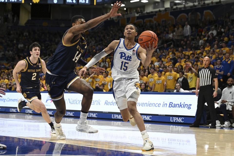 Pittsburgh guard Jaland Lowe (15) drives past Notre Dame forward Kebba Njie (14) during the first half of an NCAA college basketball game, Saturday, Feb. 3, 2024, in Pittsburgh. (AP Photo/Barry Reeger)