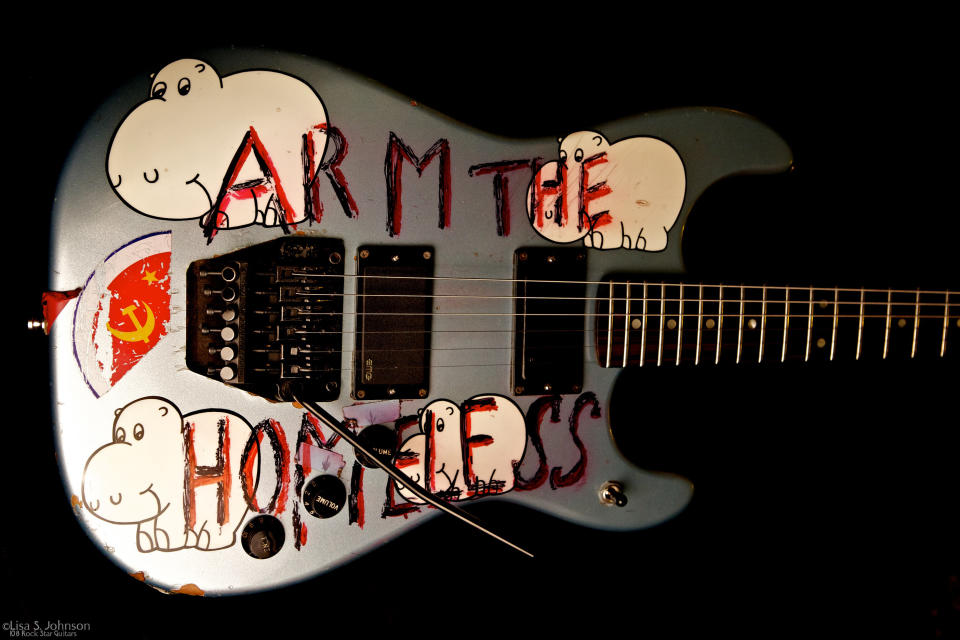 This May 31, 2011 photo provided by Lisa S. Johnson shows a guitar owned by Tom Morello. The activist-musician scrawled jarring jargon over drawings of happy hippos on the instrument, which is featured in Johnson’s new book, “108 Rock Star Guitars.” (AP Photo/Lisa S. Johnson)