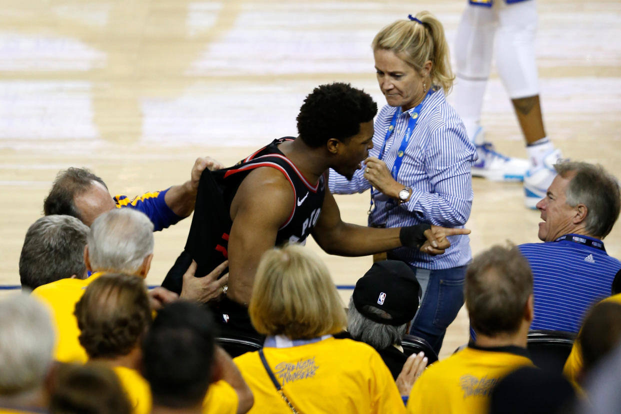 Raptors star Kyle Lowry confronts the fan who shoved him in the fourth quarter of Game 3. (Getty Images)