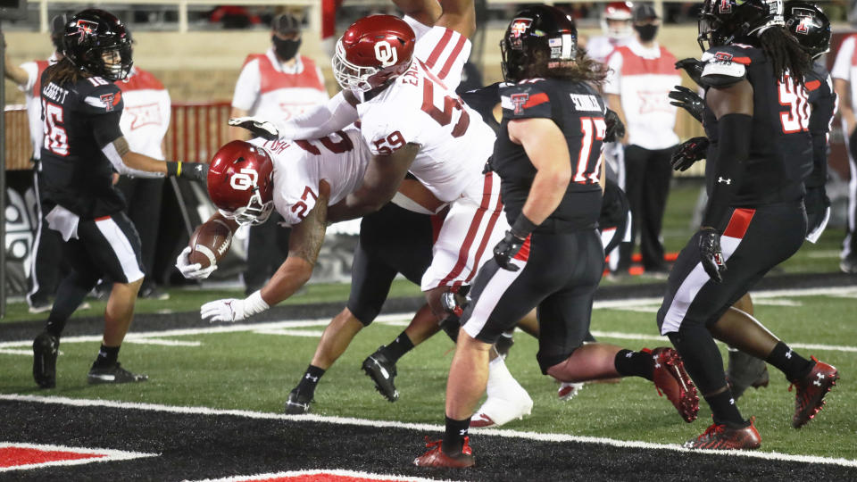 Oklahoma's Jeremiah Hall scores a touchdown against Texas Tech during the first half of an NCAA college football game Saturday, Oct. 31, 2020, in Lubbock, Texas. (AP Photo/Mark Rogers)
