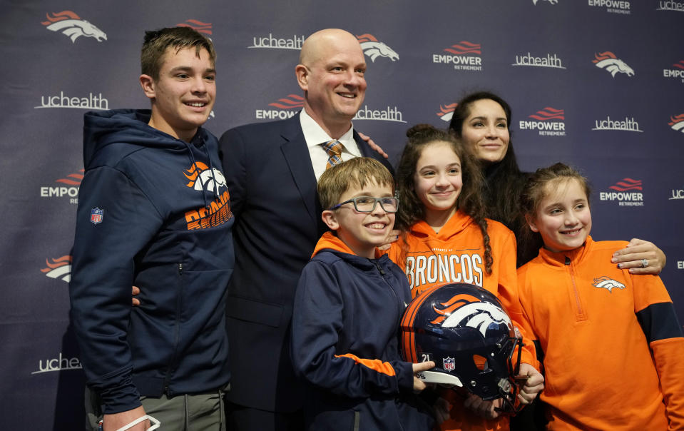 New Broncos head coach Nathaniel Hackett, second from left in back, poses for a photograph with his family after a news conference to introduce him as the team's new NFL head football coach Friday, Jan. 28, 2022, in Englewood, Colo. Hackett's children are, Harrison, 13, back left, London, 11, front left, Briar, 12, front center, and Everly, 9. His wife, Megan, is back right. (AP Photo/David Zalubowski)