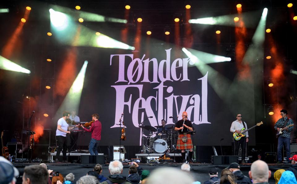 Scottish band Peatbog Faeries performs on the open air stage at the Toender Festival of folk music as Storm Lilian approaches Jutland, Denmark (Ritzau Scanpix/AFP via Getty Ima)