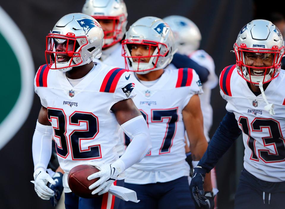 New England Patriots safety Devin McCourty (32) reacts after an interception during the second half of an NFL football game against the New York Jets, Sunday, Oct. 30, 2022, in East Rutherford, N.J. (AP Photo/Noah K. Murray)