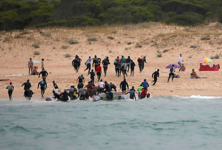 Migrants disembark from a dinghy at "Del Canuelo" beach after they crossed the Strait of Gibraltar sailing from the coast of Morocco, in Tarifa, sourthern Spain, July 27, 2018. REUTERS/Jon Nazca