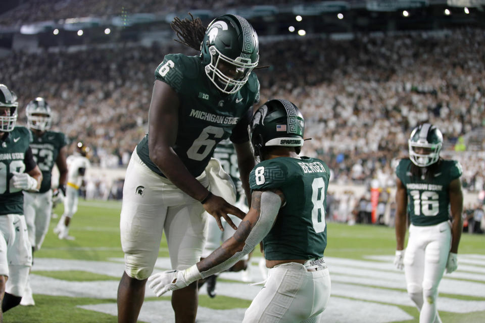 Michigan State running back Jalen Berger (8) and tight end Maliq Carr (6) celebrate Berger's rushing touchdown against Central Michigan during the third quarter of an NCAA college football game Friday, Sept. 1, 2023, in East Lansing, Mich. (AP Photo/Al Goldis)