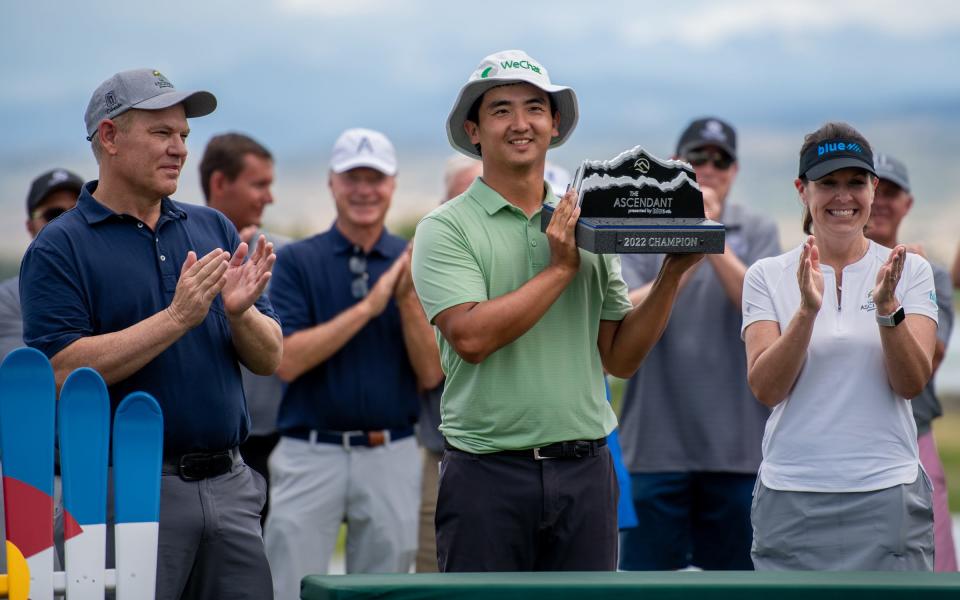 Professional golfer Zecheng "Marty" Dou is awarded the championship trophy after winning The Ascendant at TPC Colorado in Berthoud on July 3, 2022.