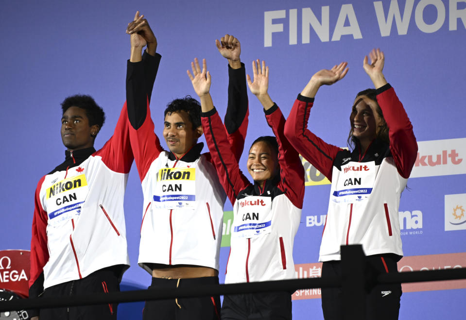 Silver medalist team of Canada celebrates after the Mixed 4x100m Freestyle Relay at the 19th FINA World Championships in Budapest, Hungary, Friday, June 24, 2022. (AP Photo/Anna Szilagyi)