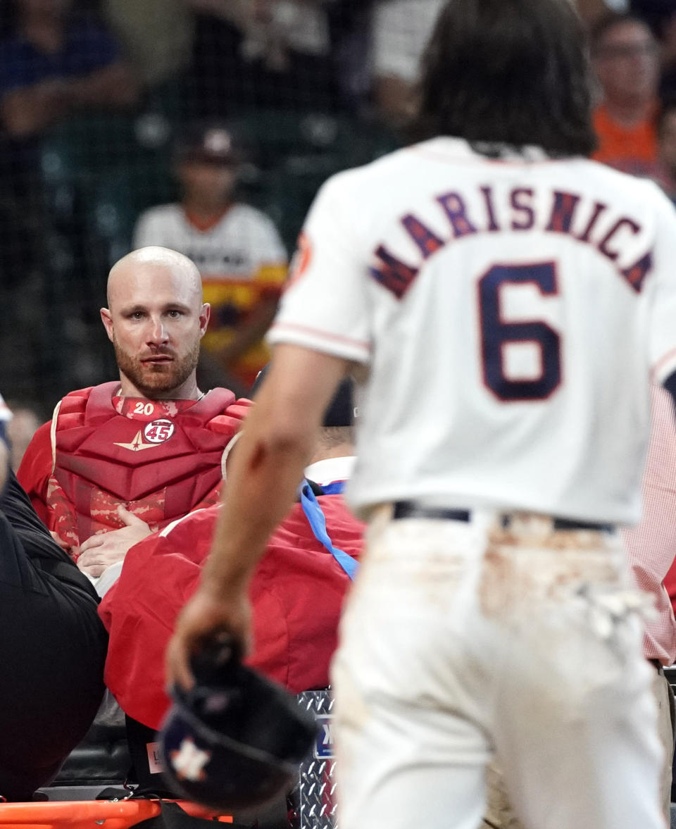 Los Angeles Angels' Jonathan Lucroy, left, is carted off the field after colliding with Houston Astros' Jake Marisnick (6) at home plate during the eighth inning of a baseball game Sunday, July 7, 2019, in Houston. (AP Photo/David J. Phillip)