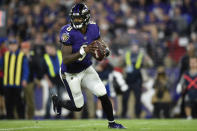 Baltimore Ravens quarterback Lamar Jackson (8) works out of the pocket against the Tennessee Titans during the first half an NFL divisional playoff football game, Saturday, Jan. 11, 2020, in Baltimore. (AP Photo/Gail Burton)
