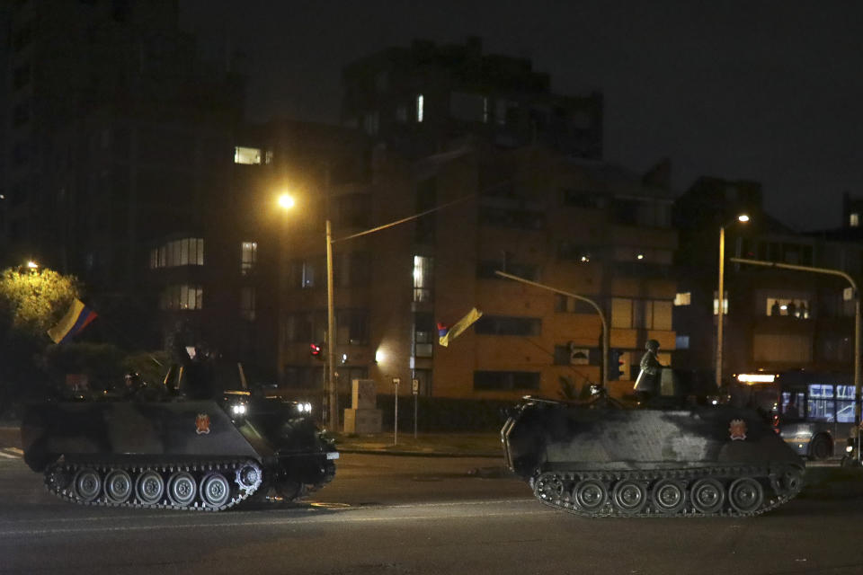 Military vehicles patrol the streets in Bogota, Colombia, Saturday, Nov. 23, 2019. Authorities in Colombia are maintaining a heightened police and military presence in the nation's capital following two days of unrest. (AP Photo/Ivan Valencia)
