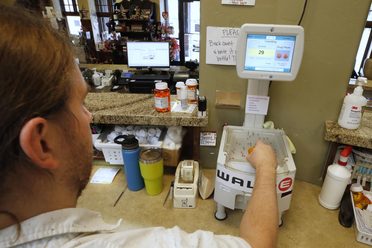 A pharmacy tech fills prescriptions at Rock Canyon Pharmacy in Provo, Utah on May 20, 2020. (Photo by GEORGE FREY/AFP via Getty Images)