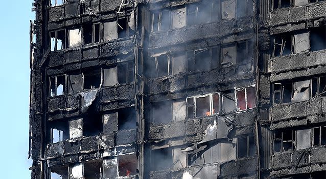 Flames could still be seen burning inside the building hours after the fire started. Photo: AP