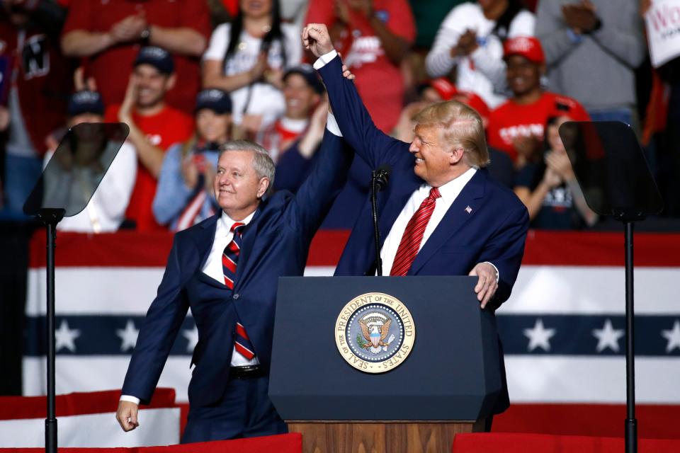 Sen. Lindsey Graham, R-S.C., left, stands onstage with President Donald Trump during a campaign rally, in North Charleston, S.C., pn Feb. 28, 2020.