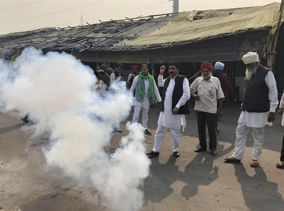 Farmers light firecrackers to celebrate news of the repeal of farm laws they were protesting against, in Ghazipur, on the outskirts of New Delhi, India, Friday, Nov. 19, 2021. Prime Minister Narendra Modi has said his government will withdraw the controversial farm laws that were met with year-long demonstrations from tens of thousands of farmers who said the laws will shatter their livelihoods. The drawn-out demonstrations have posed one of the biggest political challenges to Modi, who swept the polls for the second time in 2019. (AP Photo/Manish Swarup)