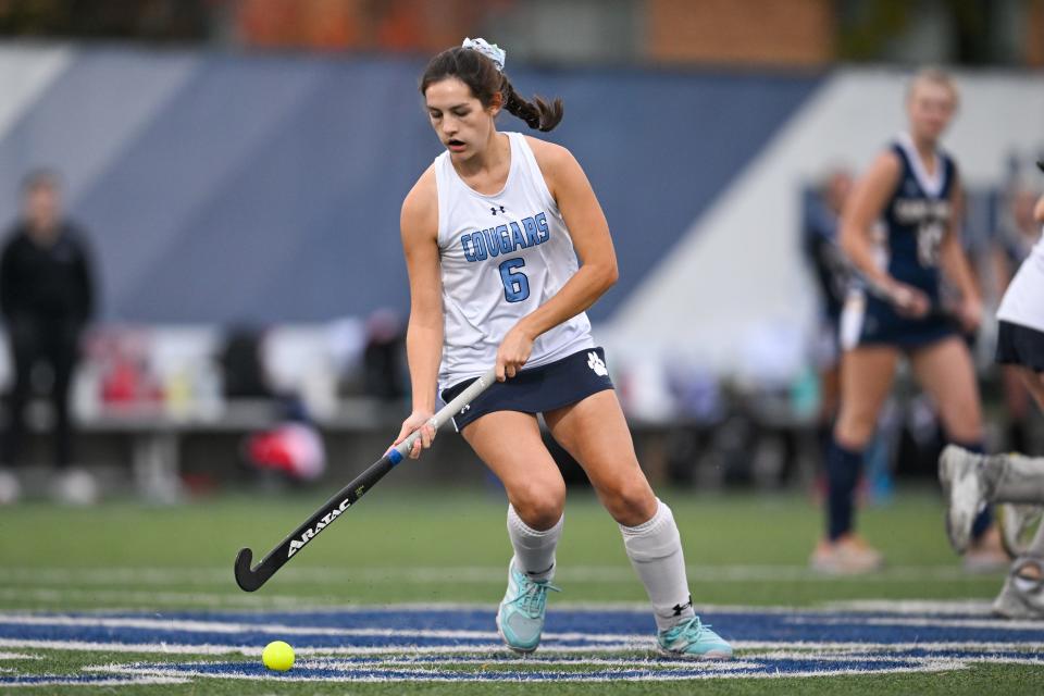 Mount Notre Dame Mid Laura Fagan (6) advances the ball at the Division I regional semifinal field hockey game between St. Ursula Academy and Mount Notre Dame on Tuesday, Oct. 24, 2023.