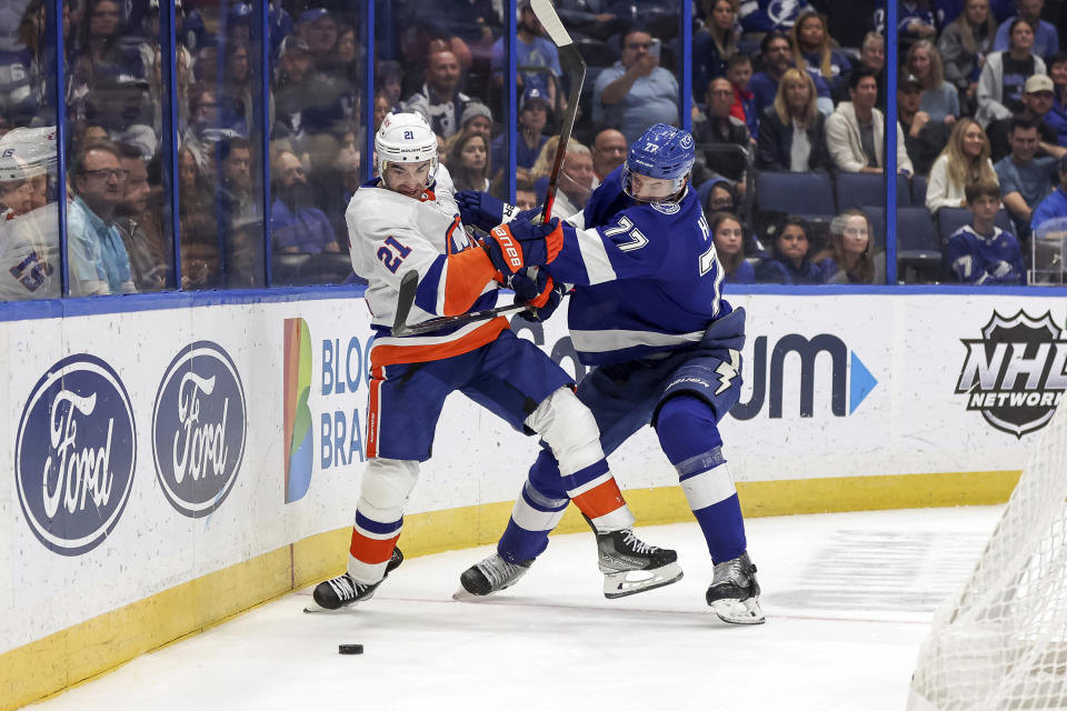 Tampa Bay Lightning's Victor Hedman (77) checks New York Islanders' Kyle Palmieri during the first period of an NHL hockey game Monday, Nov. 15, 2021, in Tampa, Fla. (AP Photo/Mike Carlson)