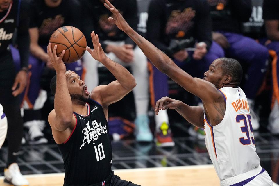 Los Angeles Clippers guard Eric Gordon (left) shoots as Phoenix Suns forward Kevin Durant defends during the first half in Game Four of a first-round NBA basketball playoff series on April 22, 2023, in Los Angeles.